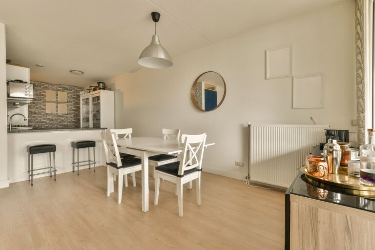 A dining area with white table and chairs