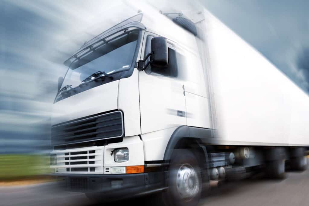 A speeding moving truck on the road