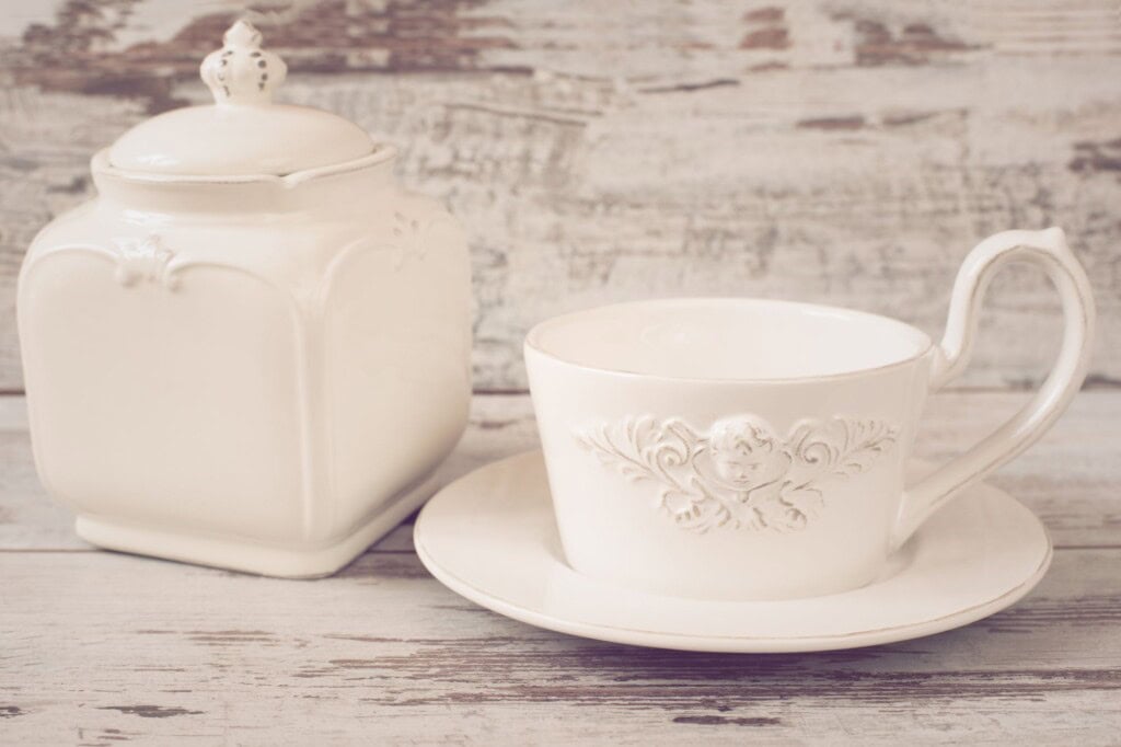 A porcelain coffee cup and jar with lid