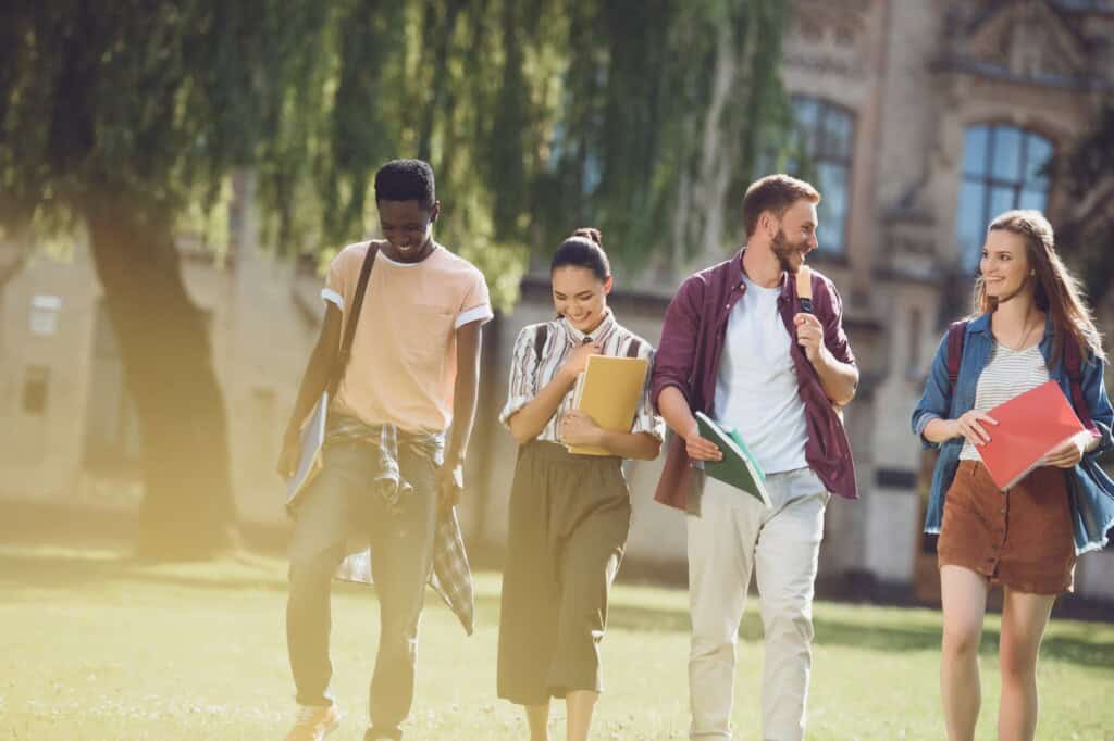 Four students walking inside the university