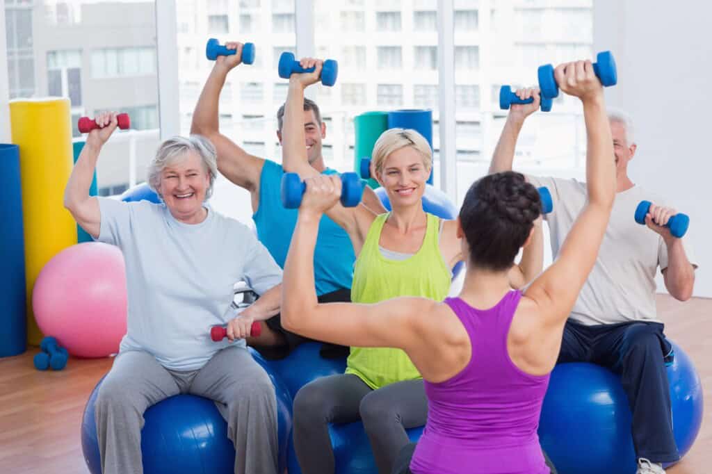 A group of people in a fitness class inside a fitness centre