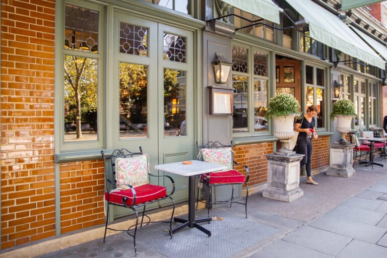 Comfy metal chairs and tables outside a British restaurant