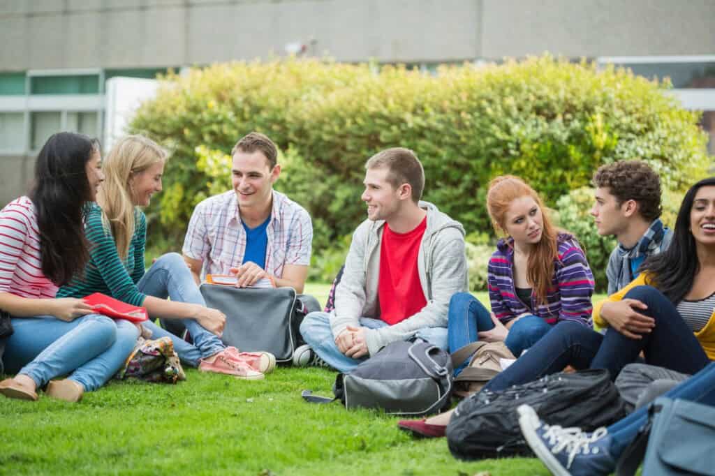 College students sitting on the lawn chatting