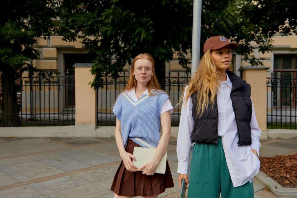 Two female students standing outside the school